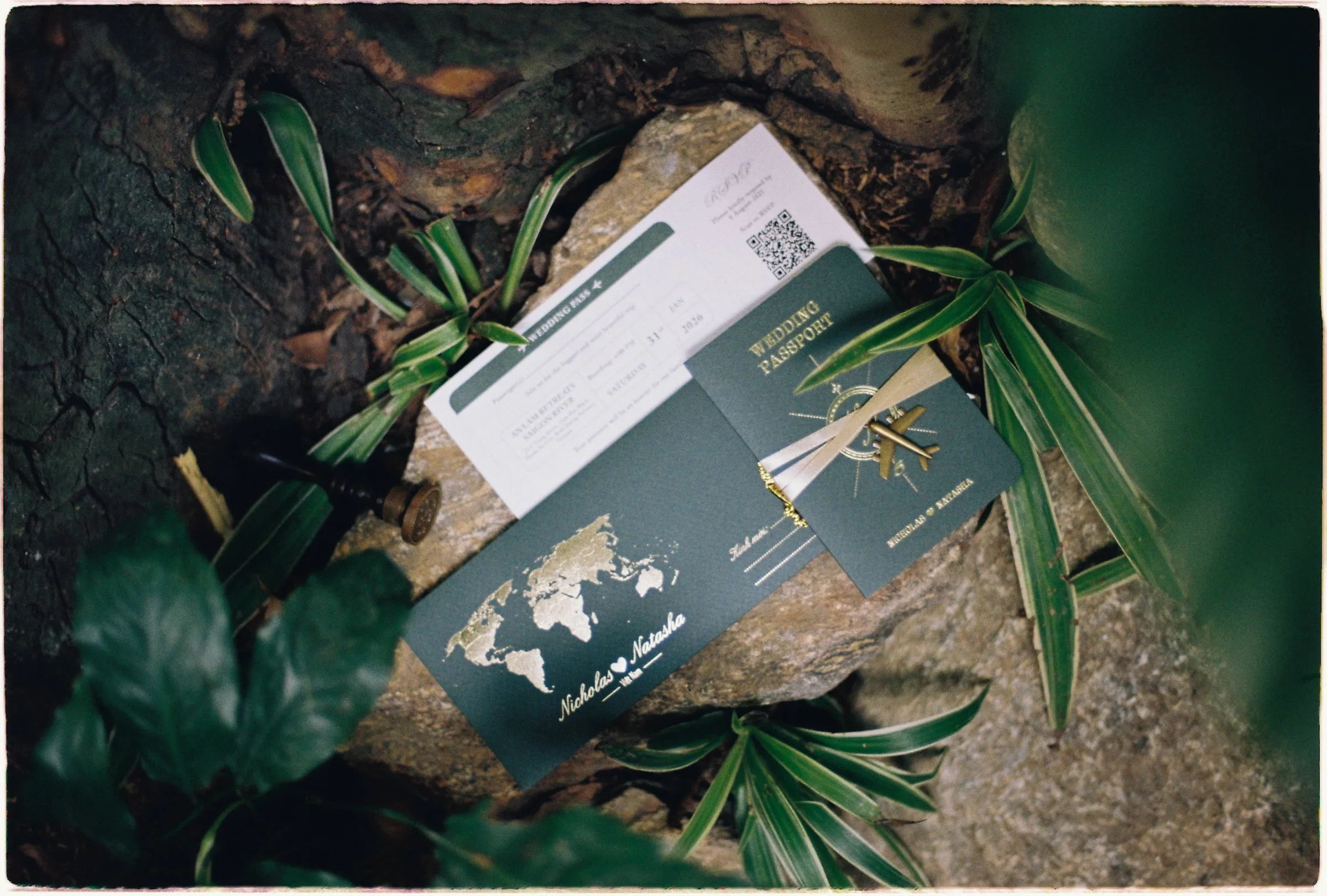 Wedding passport stationery on a mossy rock, shot on film at An Lam Retreats