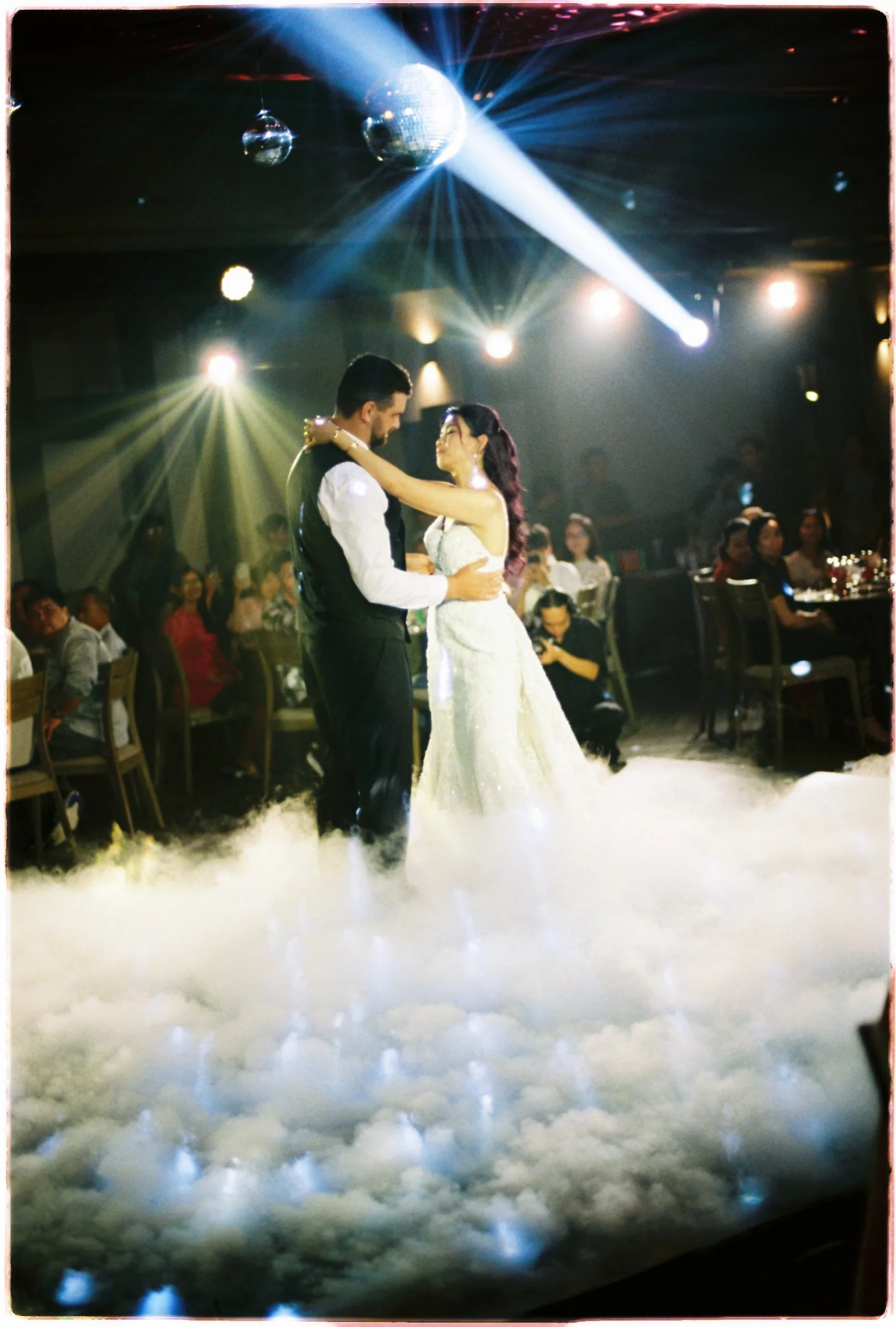 First dance under a disco ball and spotlight, shot on film