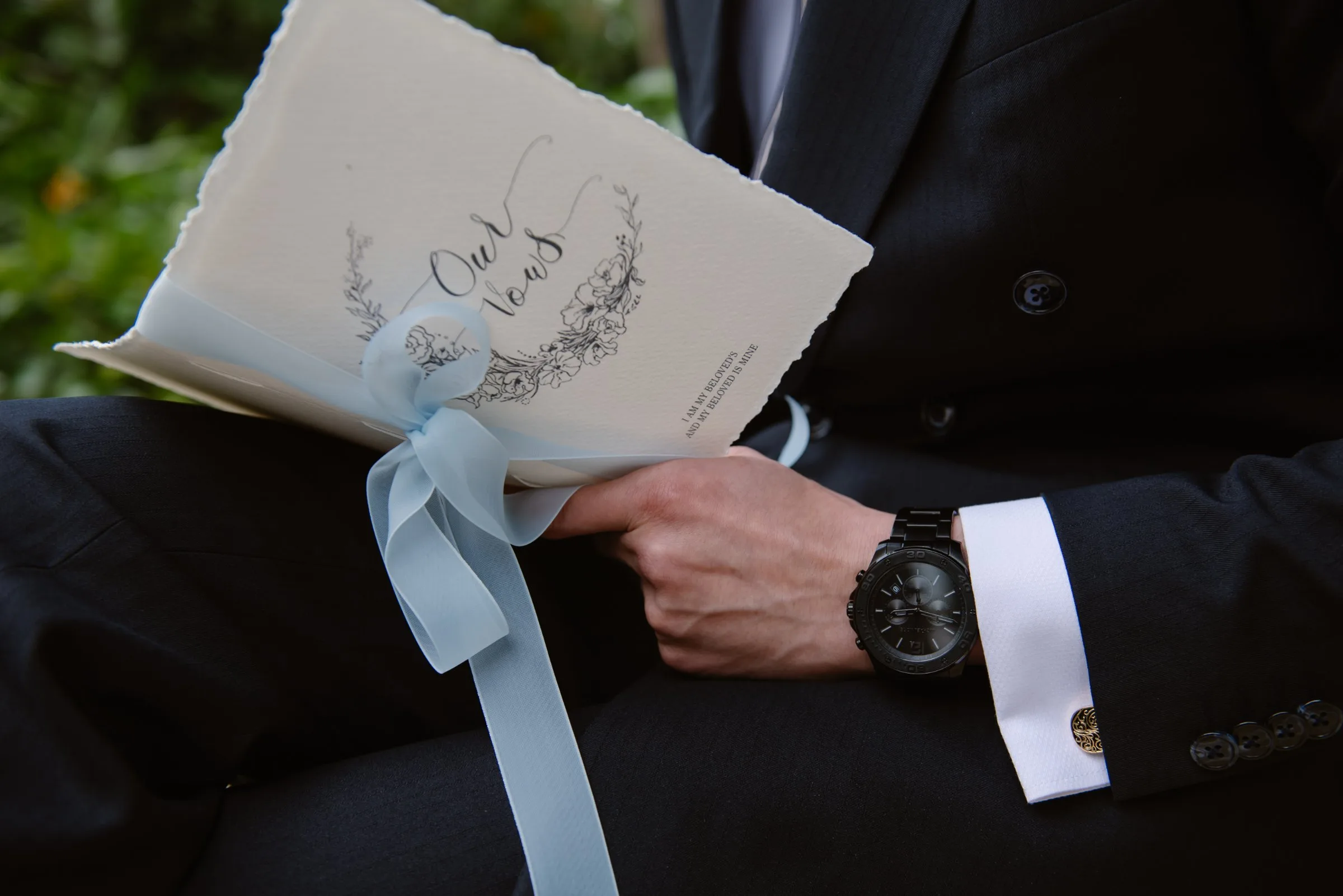 Groom holding his handwritten vows booklet before a Nha Trang wedding