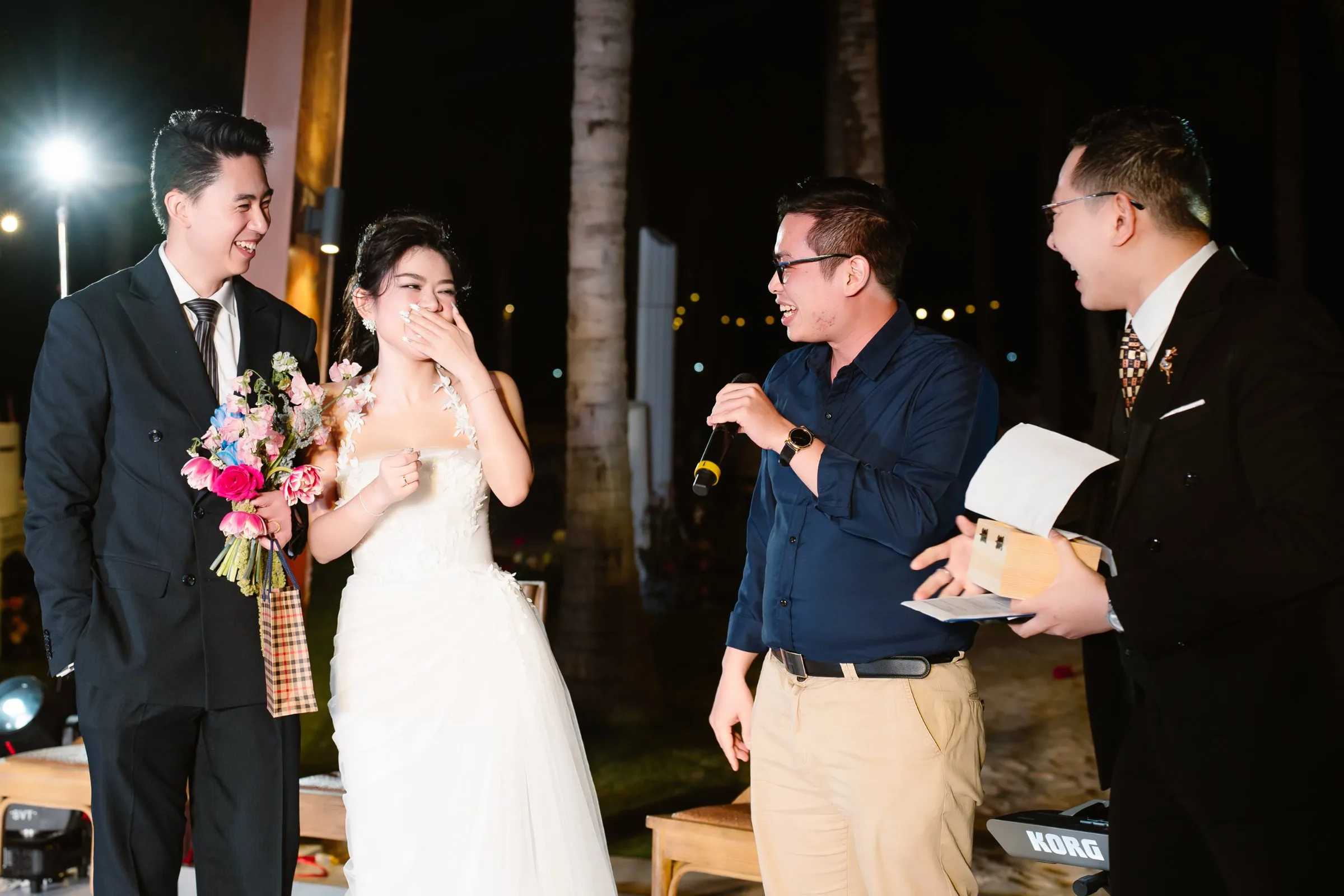 Candid laughter during a Nha Trang beach wedding reception