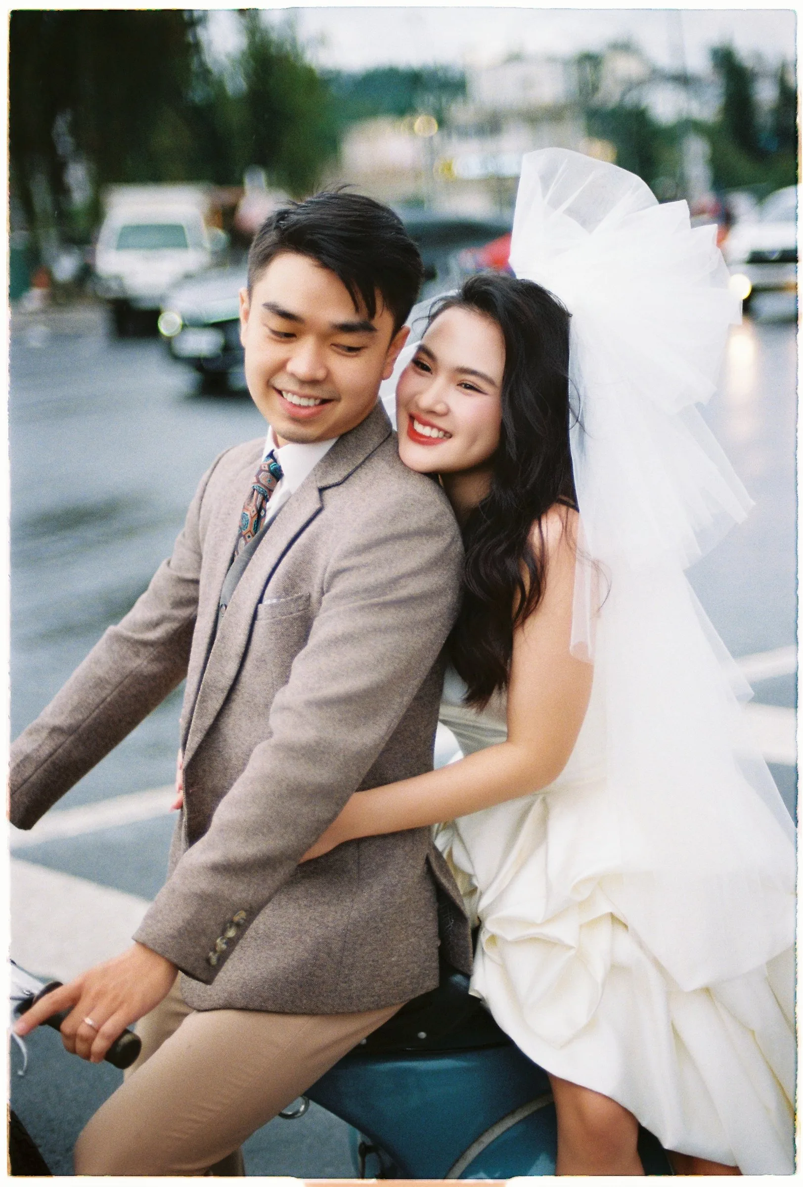 Couple sharing a scooter ride in Da Lat, bride in a veil