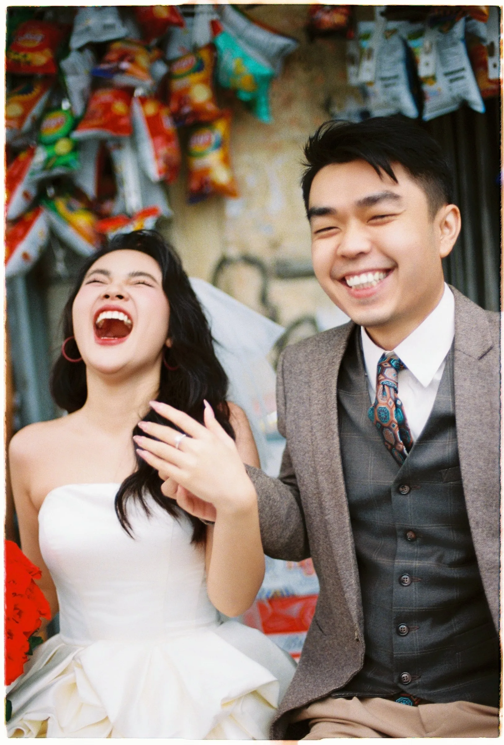 Couple laughing together at a Da Lat street shop