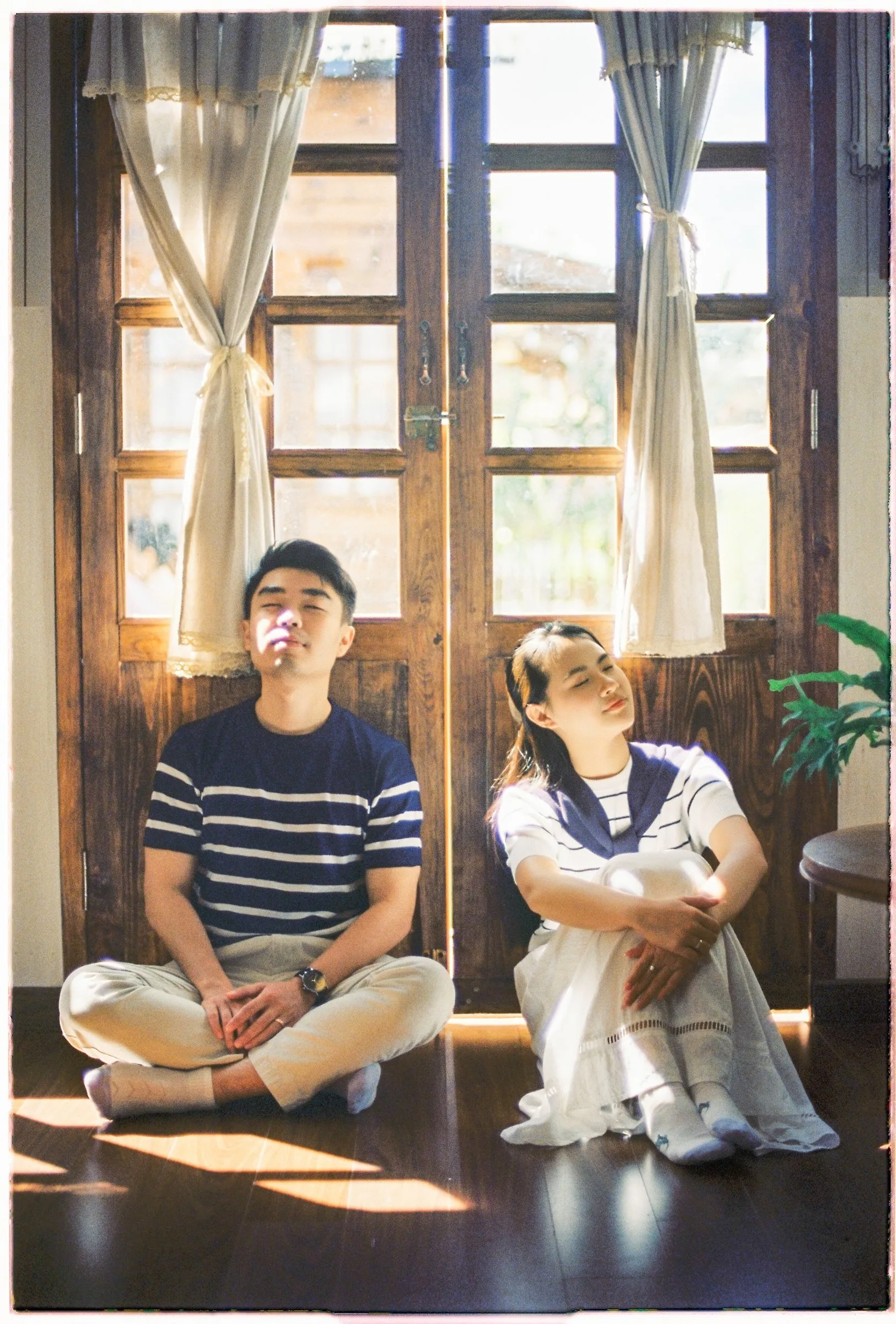 Couple resting in soft window light at a Da Lat pre-wedding