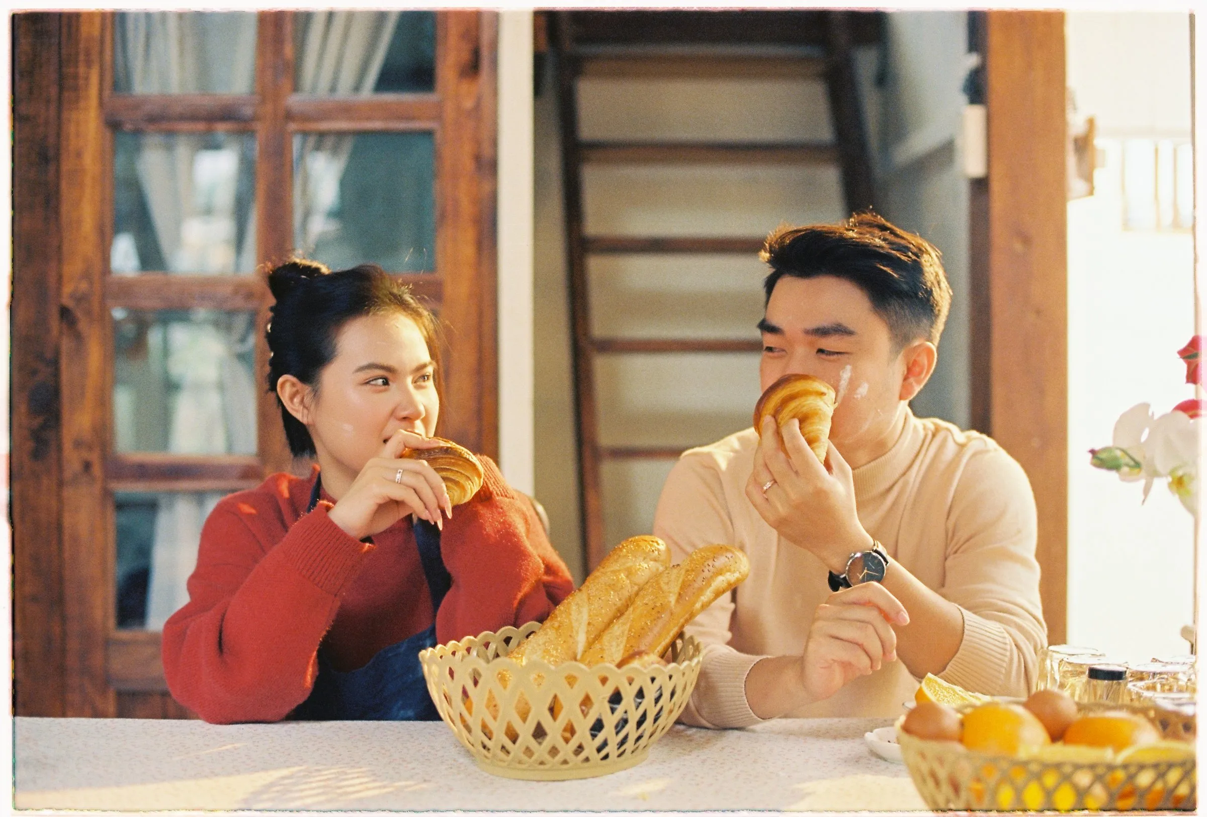 Couple sharing bread at a cosy table during a Da Lat pre-wedding