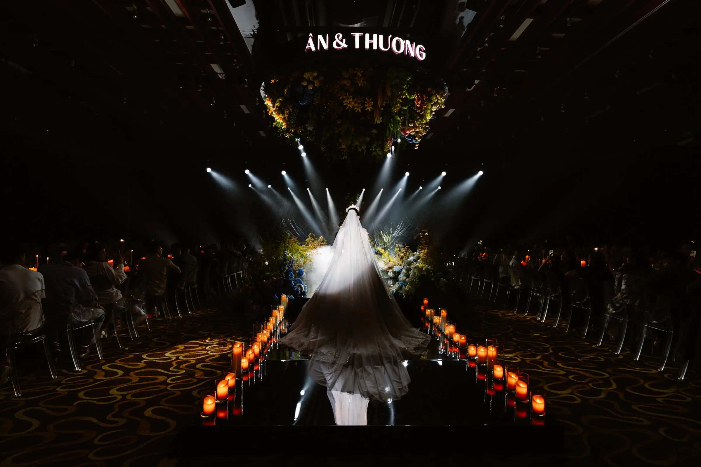 Bride walking the candlelit aisle at a Da Nang wedding, central Vietnam