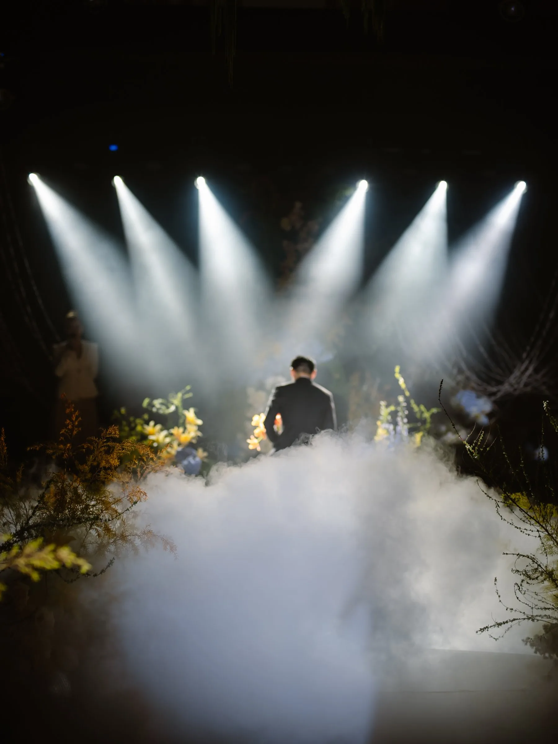 Groom walking into the spotlights at a Da Nang wedding reception