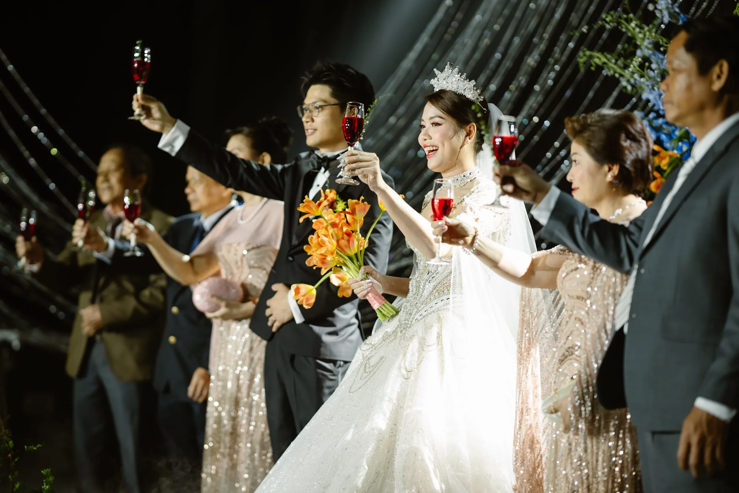 A toast with the closest of guests, glasses raised.