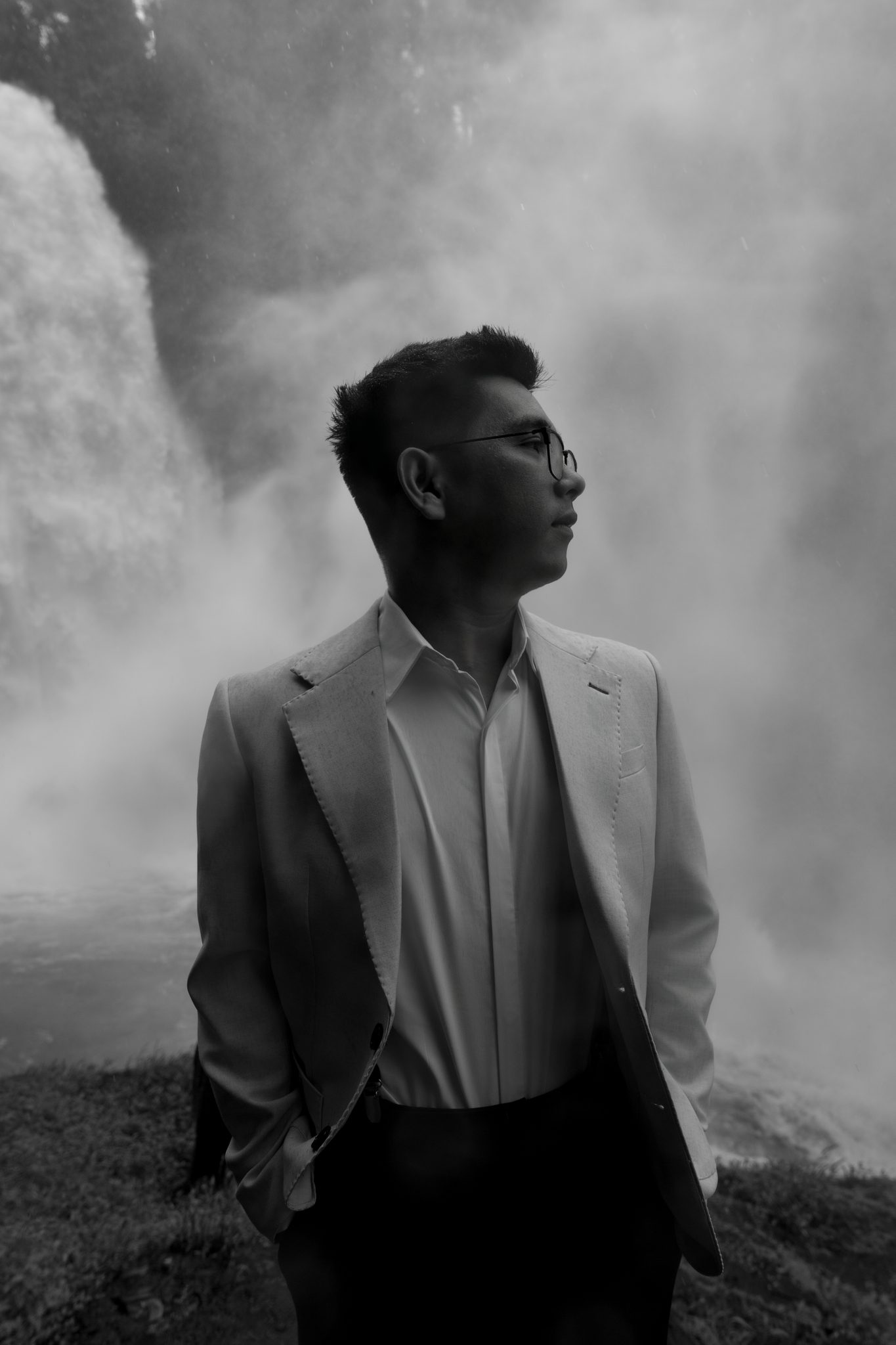 Cuong, soaked and completely unbothered, framed by the roaring water.