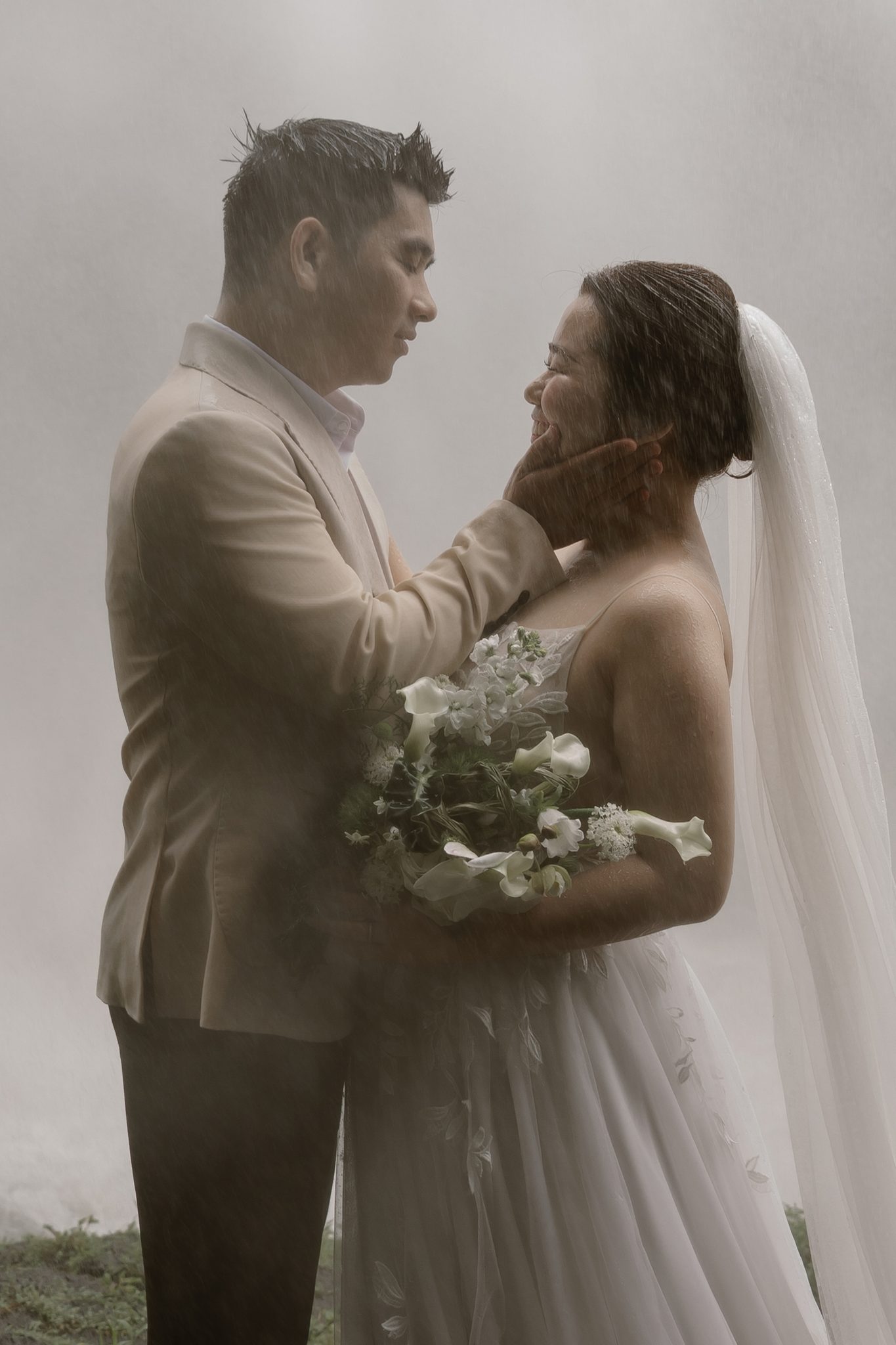 Foreheads together, warm and close, oblivious to the storm around them.