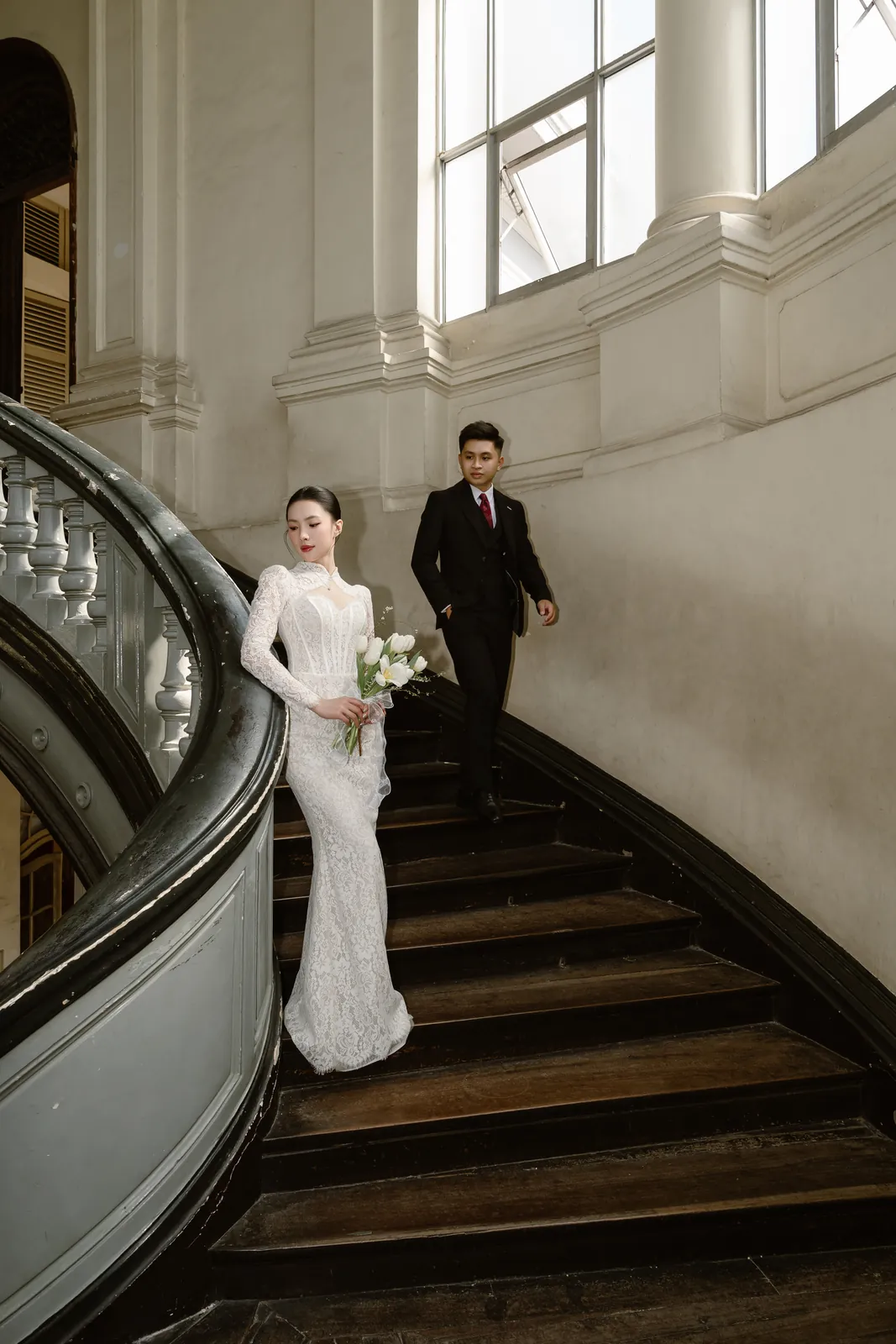 A pre-wedding portrait on the grand staircase in Saigon