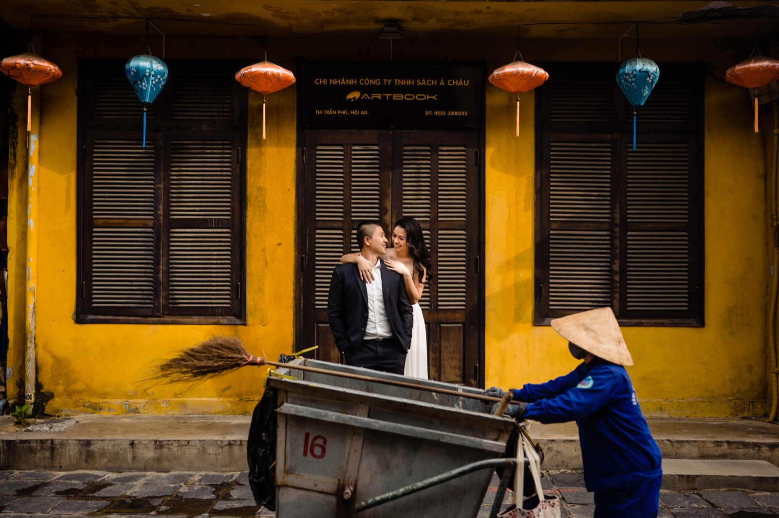 A quiet moment by an old shophouse as the morning street woke up around them.