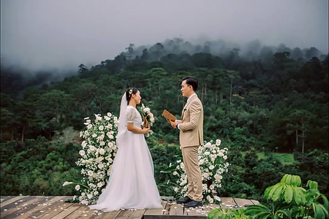 A couple exchanging vows in a misty pine forest at a Da Lat elopement, Vietnam