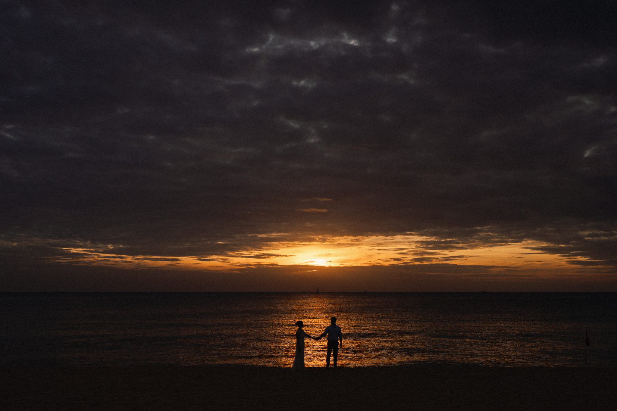 Two silhouettes against a molten Phu Quoc sunset, our favourite frame of the day.