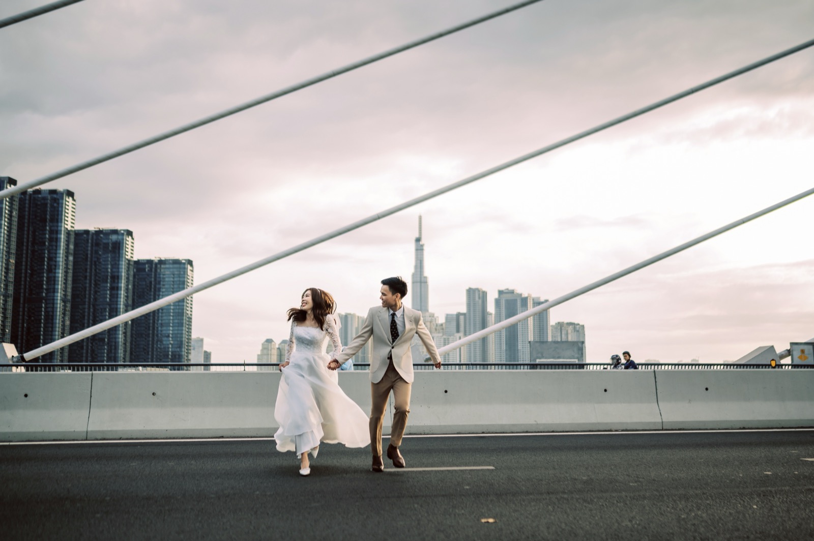 Running across the bridge, the city behind.