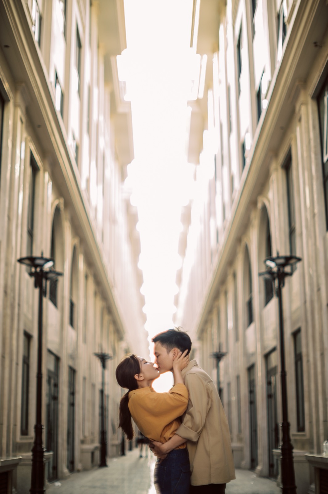 A kiss down a lamplit Saigon lane.