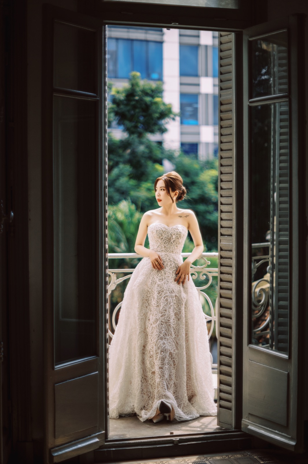 The bride in a tall shuttered doorway.