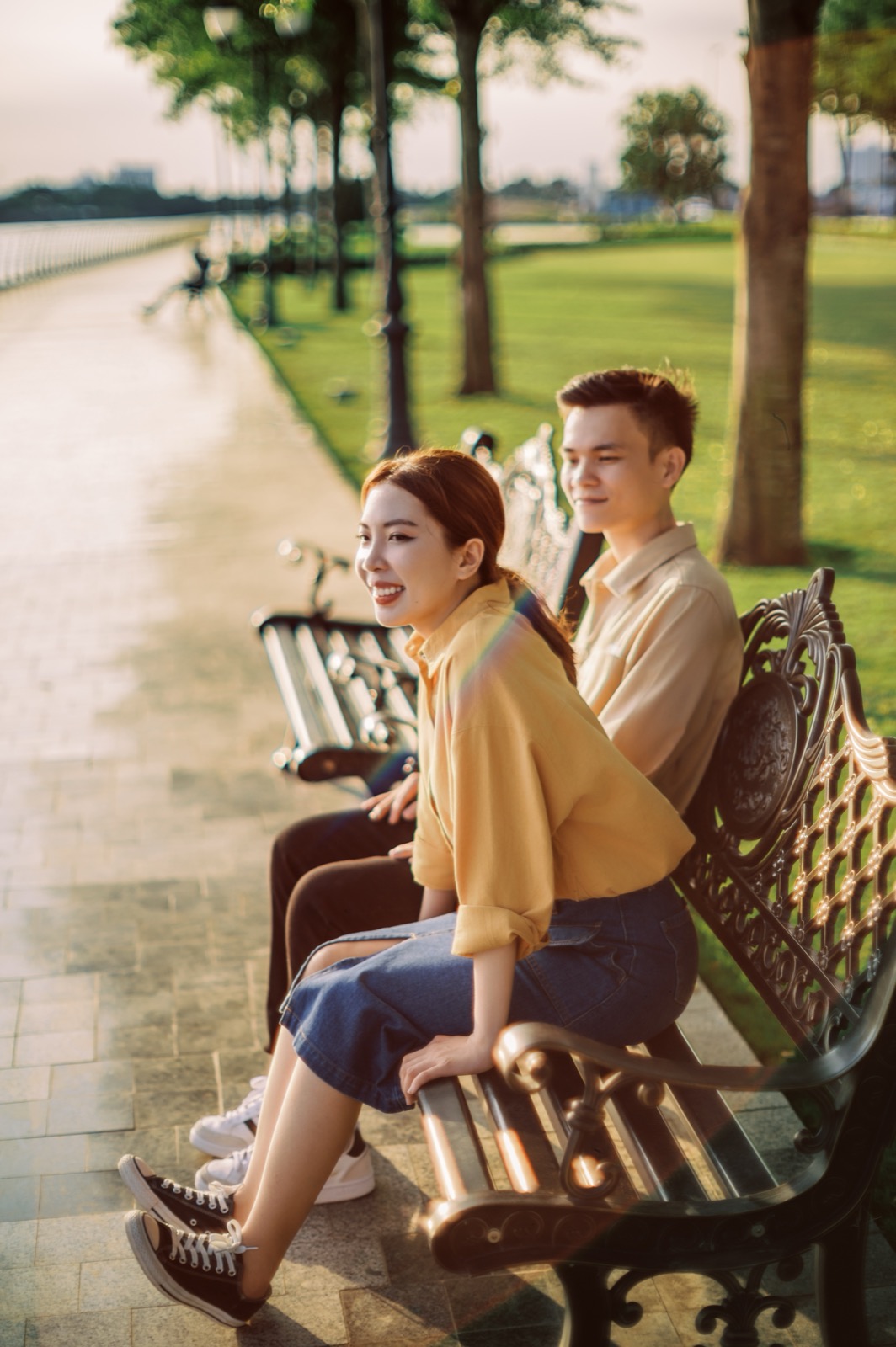 Back to back on a park bench.