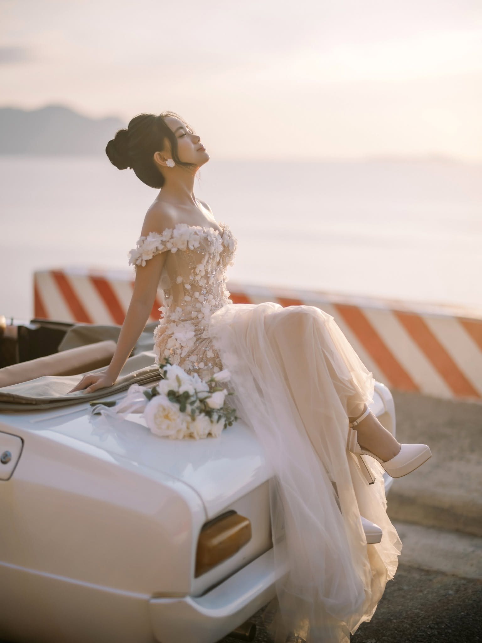 Golden light across the car and the gown.