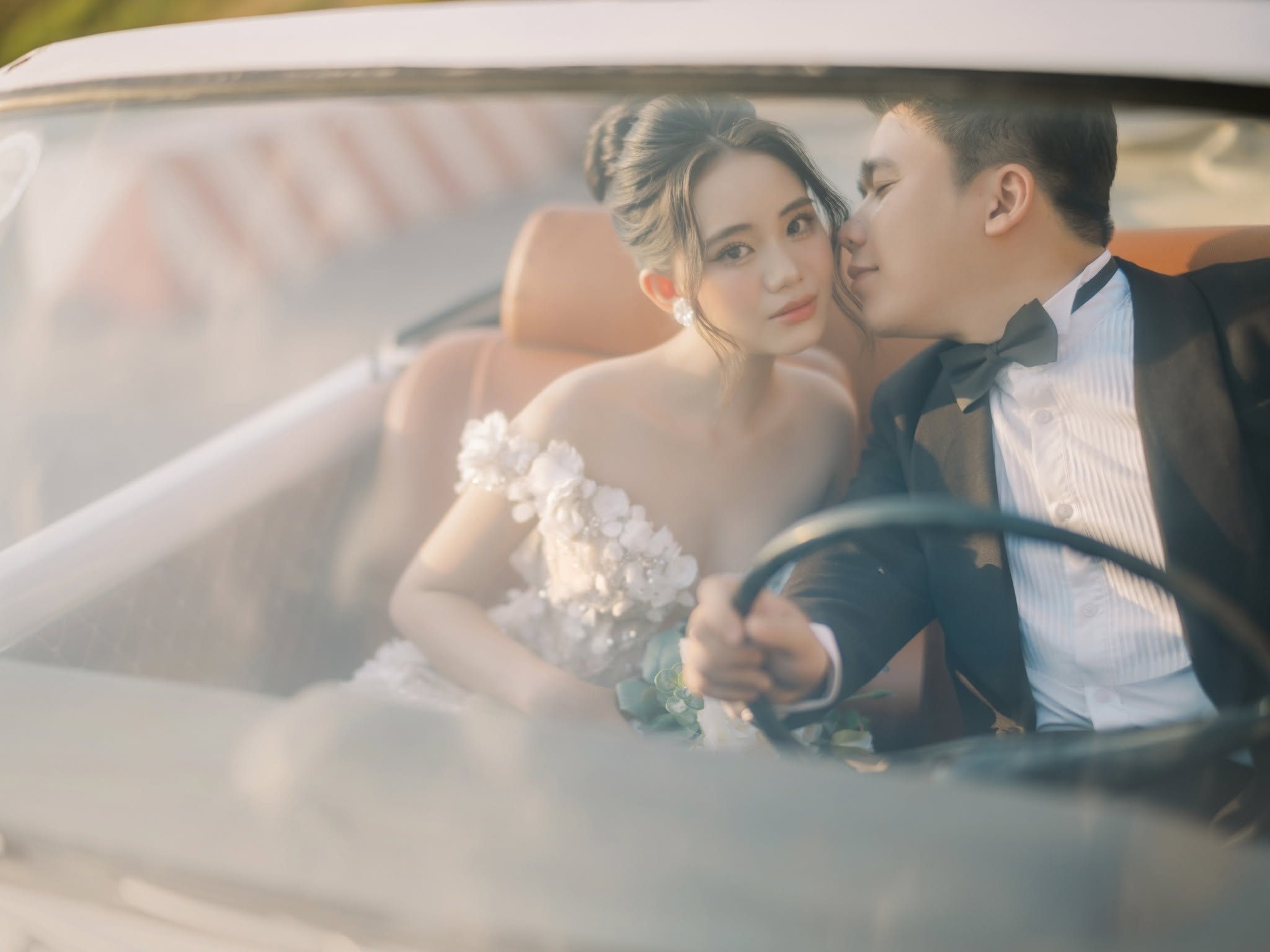 Through the windscreen, a private moment inside the car.