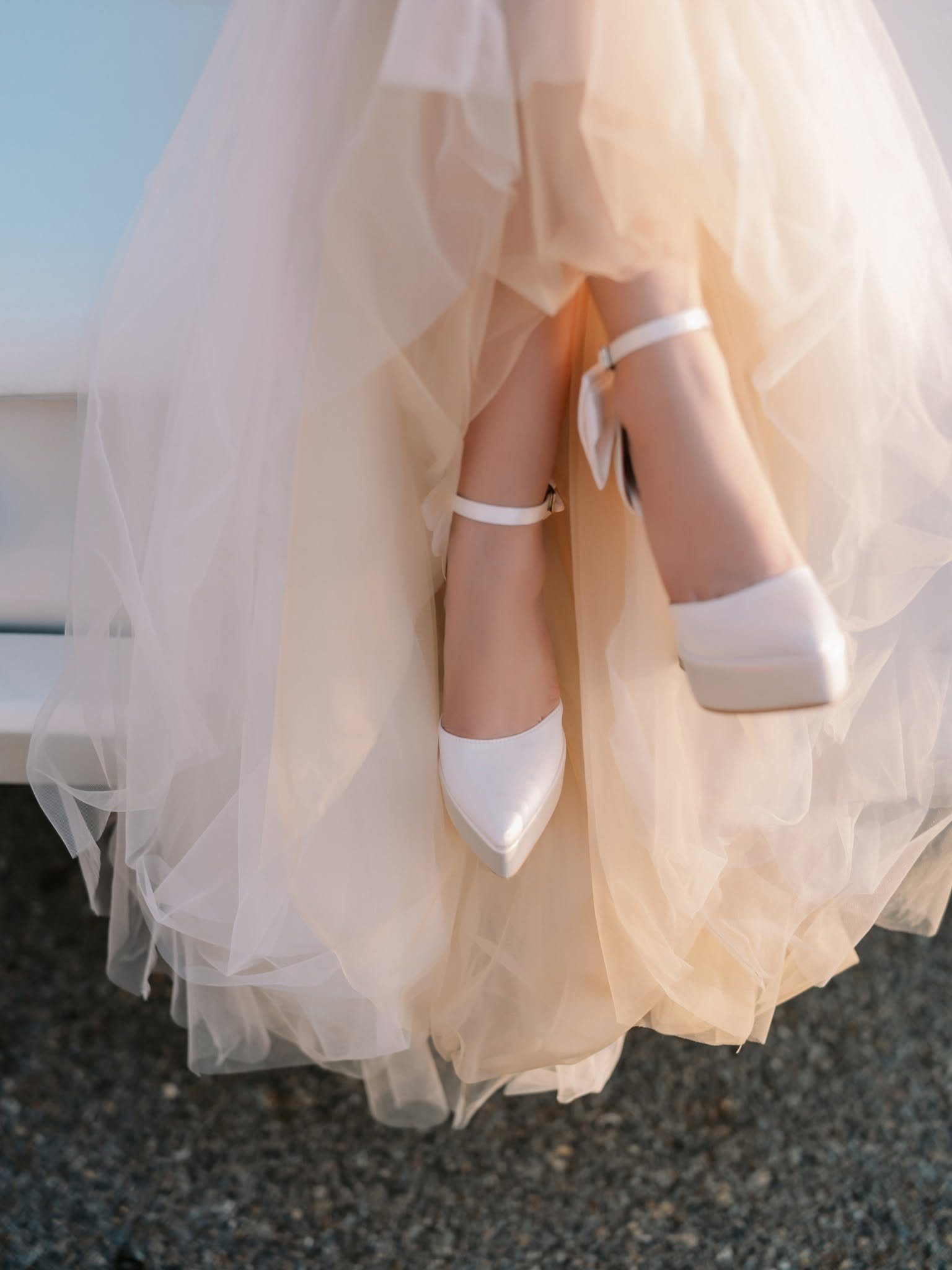 The details: heels and tulle against the tarmac.