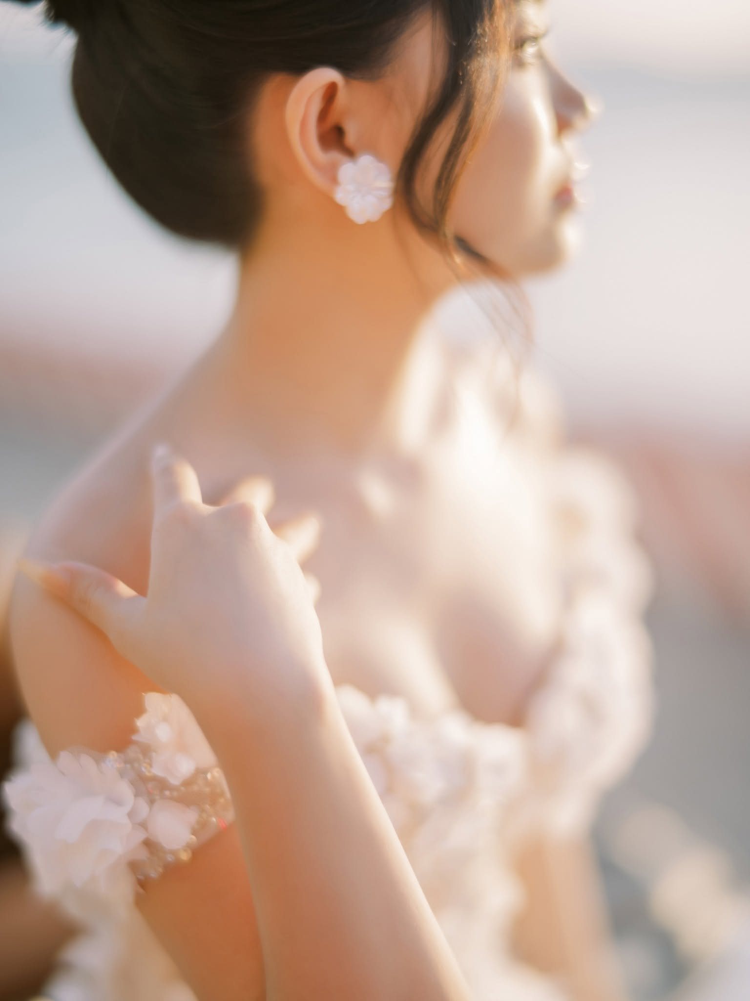 Floral appliqué on the shoulder of the gown.