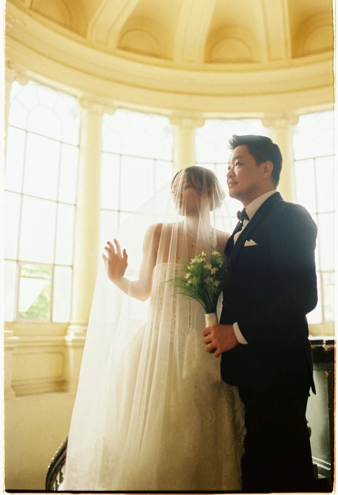 A couple under the veil at the Ho Chi Minh City Museum, Saigon