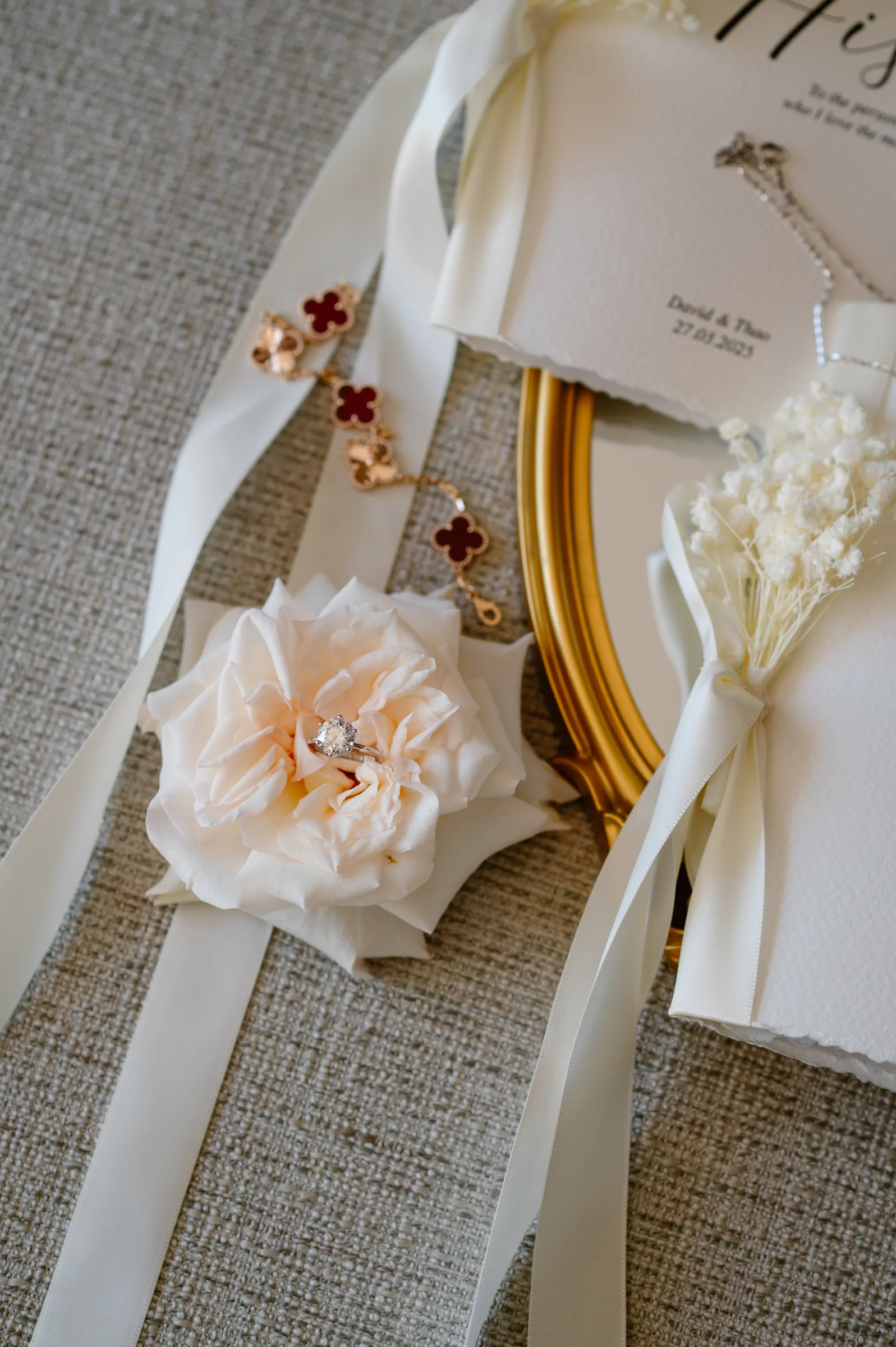 Engagement ring and stationery flat-lay at a Melia Ho Tram beach wedding