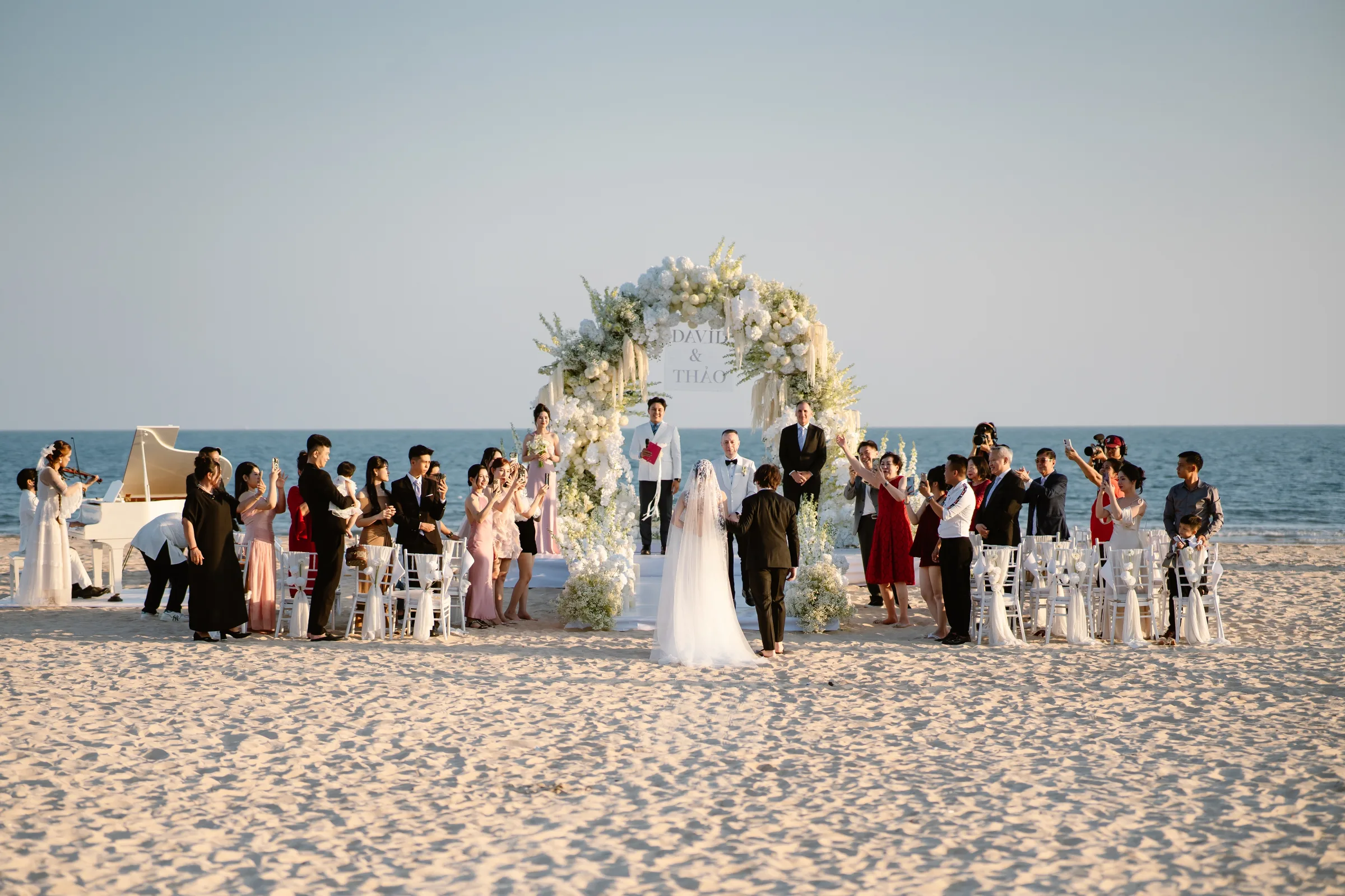 A beachfront wedding ceremony at Melia Ho Tram, one of the destinations overseas couples choose in Vietnam.