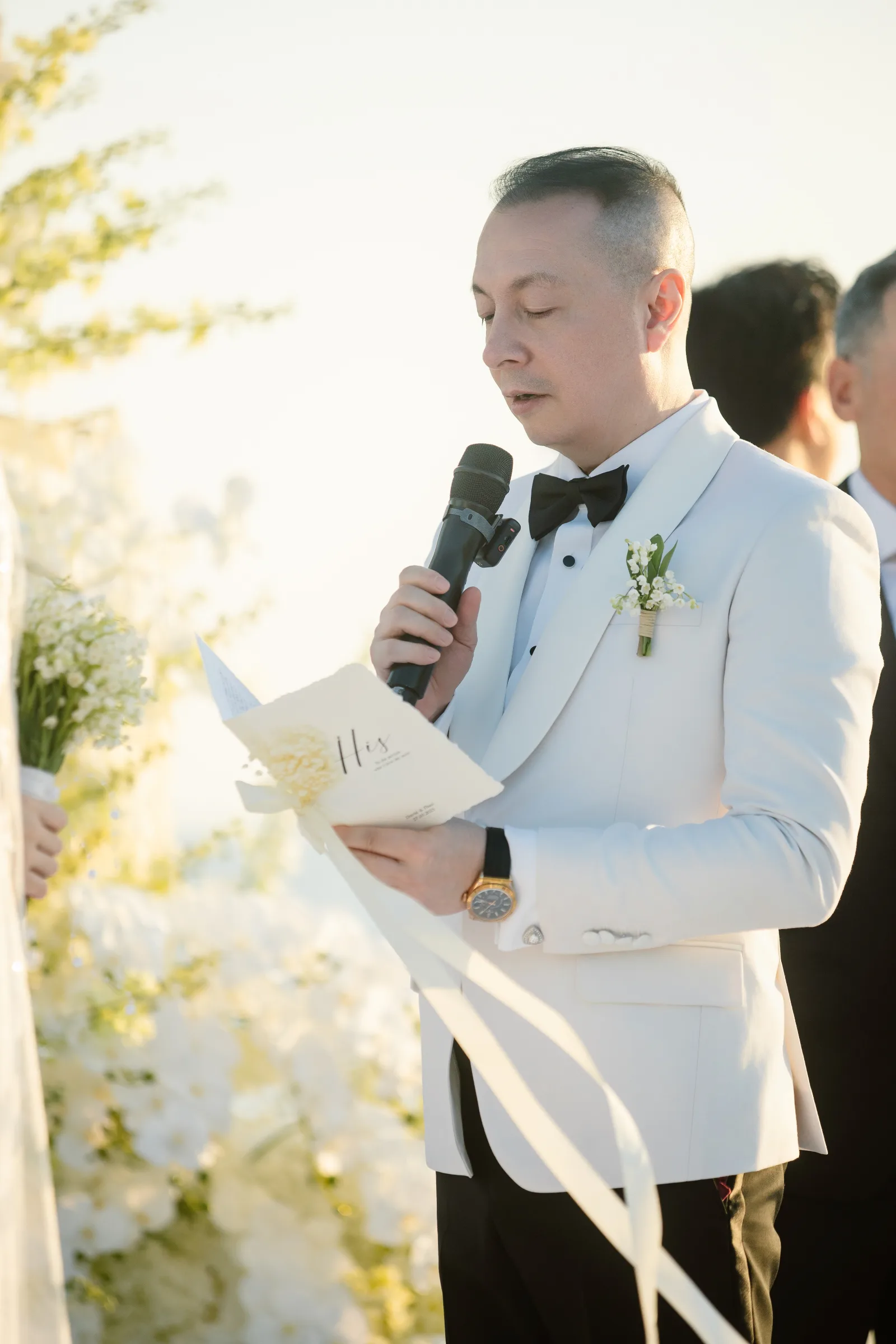 David reading his vows in the last golden light of the day.