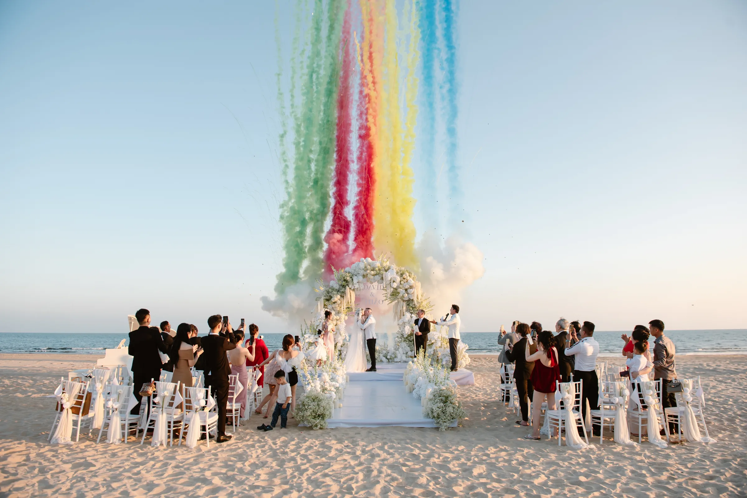 Rainbow smoke over a beach wedding ceremony at Melia Ho Tram, Vietnam