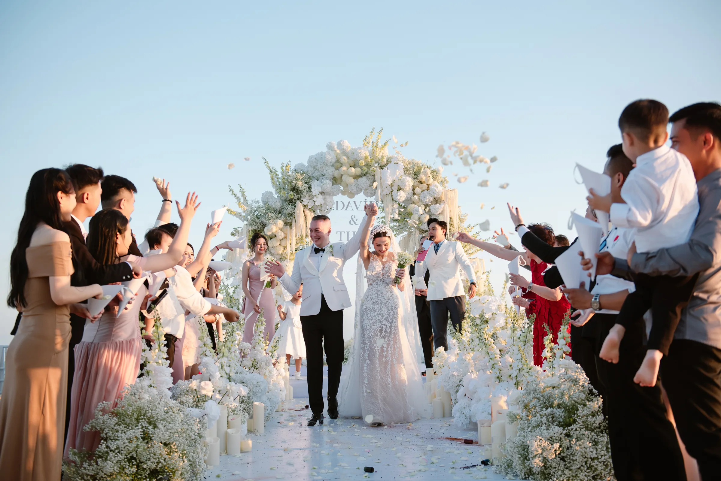 Confetti recessional at a golden-hour beach wedding at Melia Ho Tram