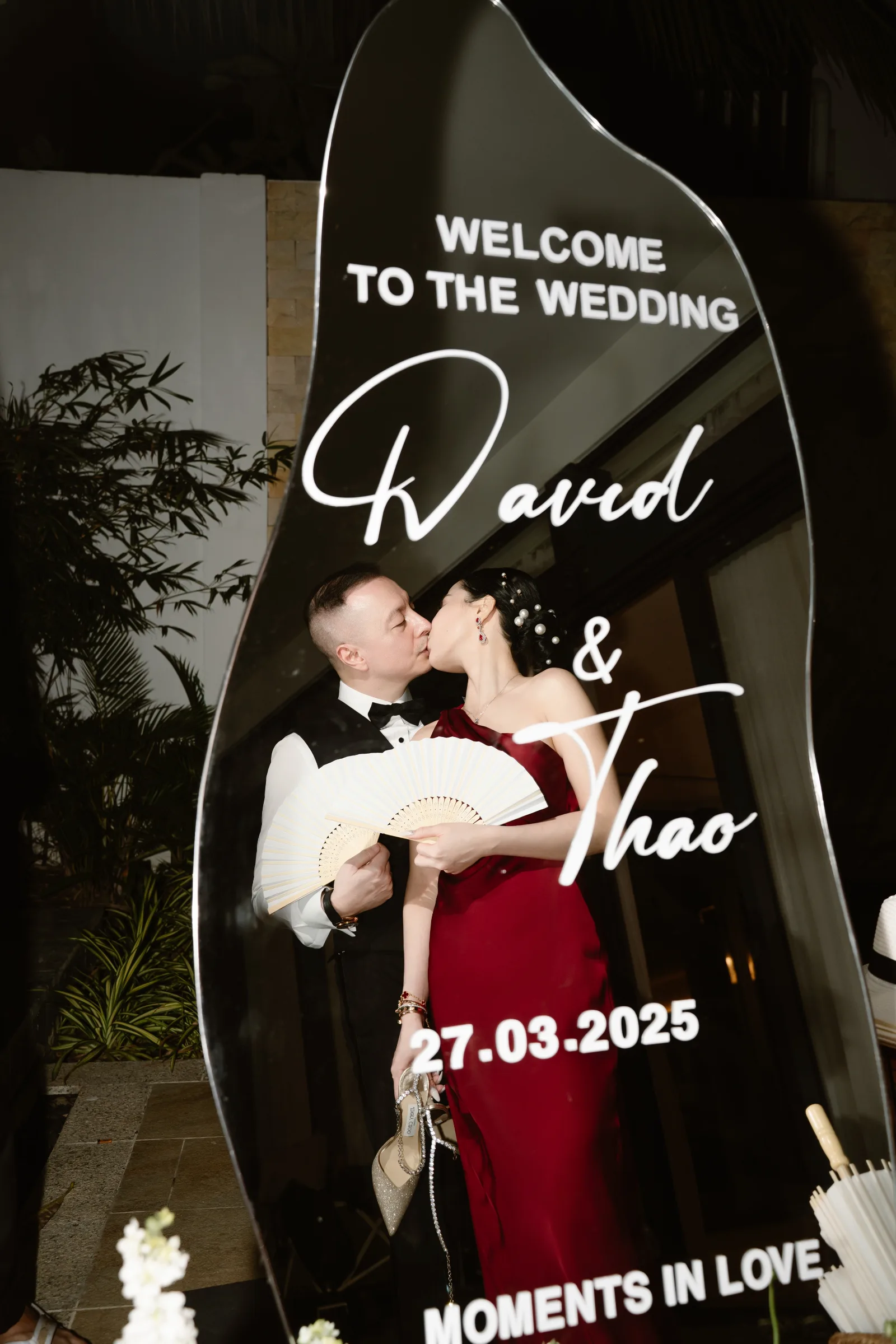 A couple kissing at a beach wedding reception, Melia Ho Tram