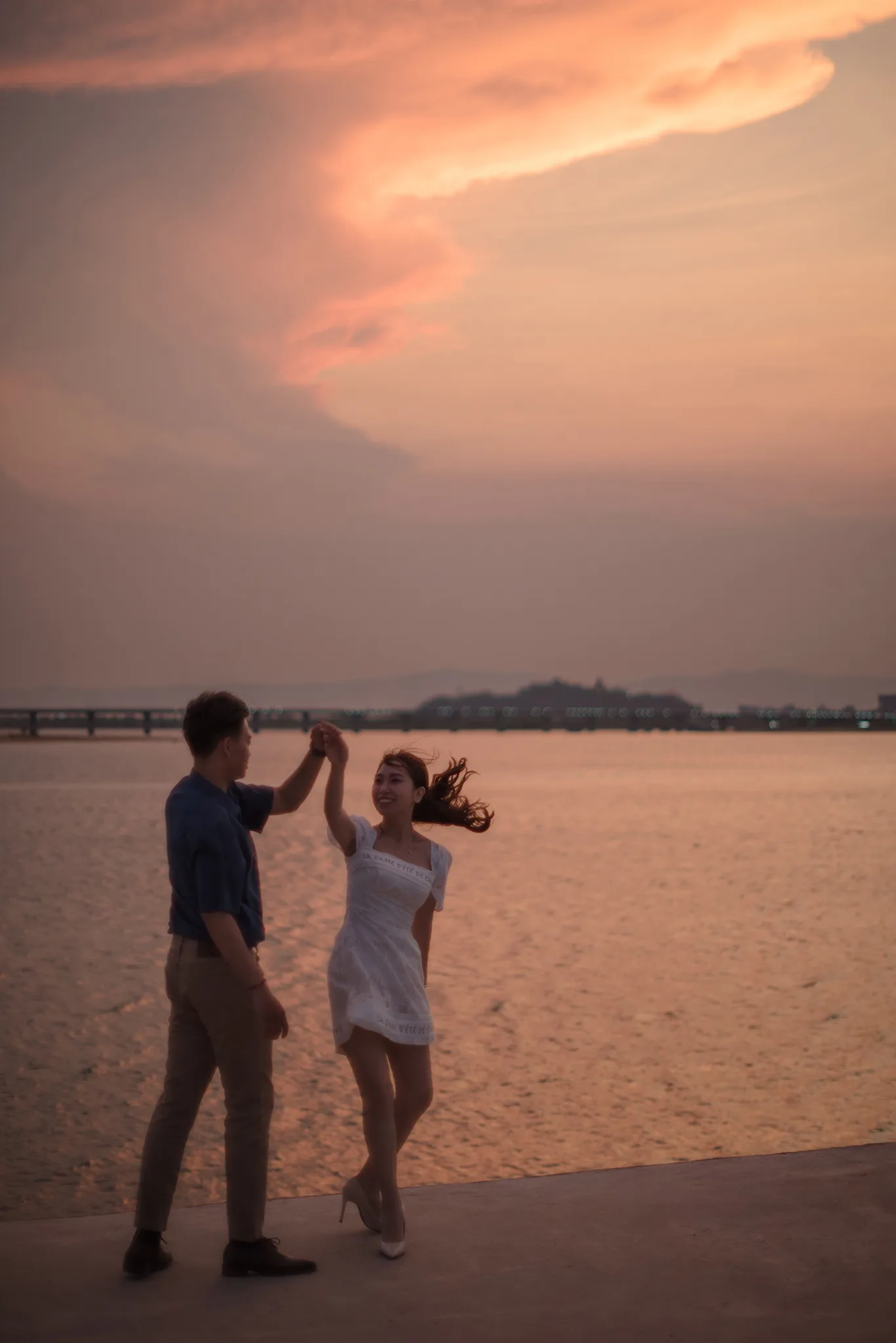 Couple dancing on a pier at sunset in Phu Yen